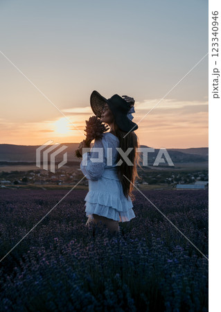 Woman in White Dress Admires Sunset in Lavender Field Woman in White Dress Admires Sunset in Lavender Field 123340946