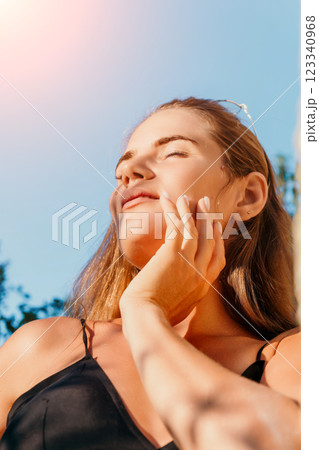 Woman, Sun, Portrait: Close-up of a woman with closed eyes enjoying the sun outdoors. 123340968