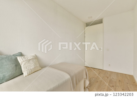 A clean, minimalist room featuring simple decor and neutral tones, emphasizing a sense of space and calm. The light-colored walls complement the light wooden floor. A clean, minimalist room featuring simple decor and neutral tones, emphasizing a sense of space and calm. The light-colored walls complement the light wooden floor. 123342203