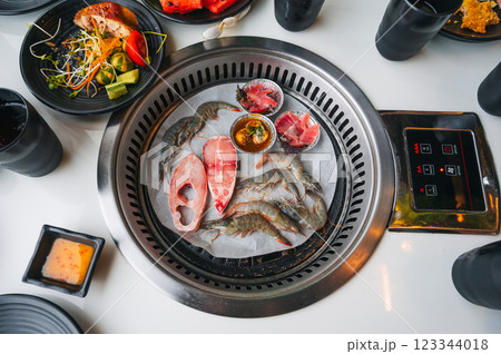 Shrimp and fish are grilled on stove in buffet in an Asian restaurant in Asia in Vietnam. Fresh seafood is fried 123344018