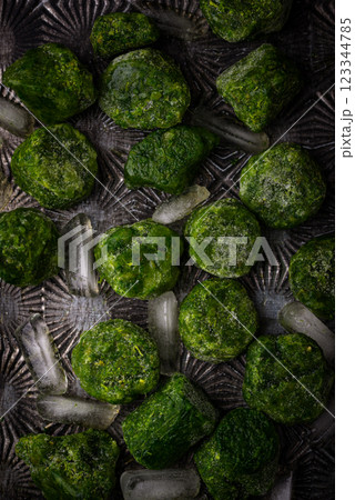 Frozen spinach green cubes in bowl 123344785