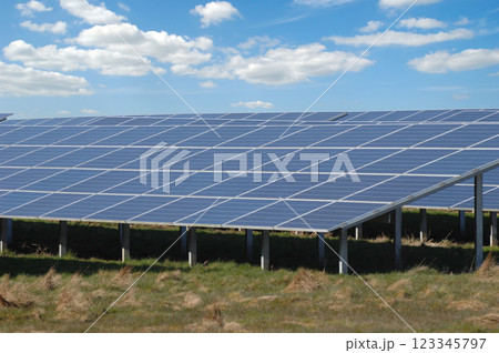 Rows of solar panels and green nature 123345797