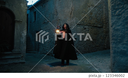 Mysterious Woman Walks Through the Alleys of the Medieval City at Night Mysterious Woman Walks Through the Alleys of the Medieval City at Night 123346002
