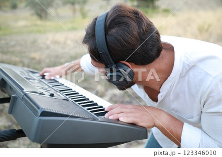 Smile Man Play The Musical Keyboard Crossing In Rhythm In The Nature 123346010
