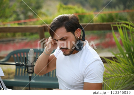 Boy Pianist Plays The Keyboard In An Outdoor Garden For A Private Party 123346039