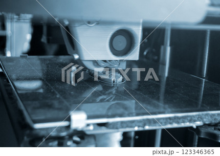 The process of printing on a 3D printer. 3D printer printing object from molten plastic close-up. Creative creation of model on 3D printer. New modern technologies of 3D printing. Additive technology 123346365