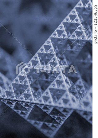 Small model of pyramid printed on 3D printer close-up. Object created on 3D printer from molten plastic. 3D printing technology. Additive modern new progressive technologies. FDM technology Blue color 123346555