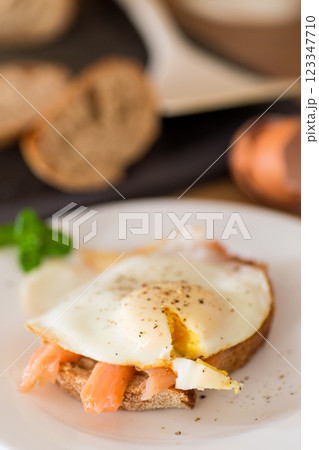 A slice of bread with lightly salted red fish and a cooked egg for breakfast A slice of bread with lightly salted red fish and a cooked egg for breakfast 123347710