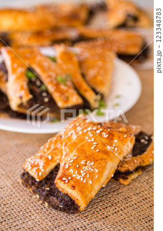 Golden puff pastries with mushroom filling and sesame seeds 123348783