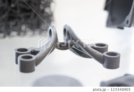Object printed on a 3D printer from molten plastic powder. Different model printed on 3D printer from melted black polyamide powder. New additive 3D printing Multi Jet Fusion MJF technology 123348905