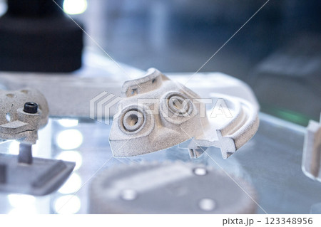 Model printed on 3D printer from grey polyamide powder close-up. Detailed prototype created on 3D printer from plastic powder. 3D printing additive powder technology, Multi Jet Fusion MJF technology Model printed on 3D printer from grey polyamide powder close-up. Detailed prototype created on 3D printer from plastic powder. 3D printing additive powder technology, Multi Jet Fusion MJF technology 123348956