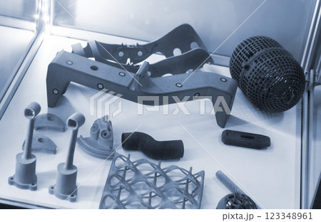 Various objects printed on a 3D printer from molten plastic powder. Different models printed on 3D printer from melted grey polyamide powder. New additive 3D printing Multi Jet Fusion MJF technology Various objects printed on a 3D printer from molten plastic powder. Different models printed on 3D printer from melted grey polyamide powder. New additive 3D printing Multi Jet Fusion MJF technology 123348961