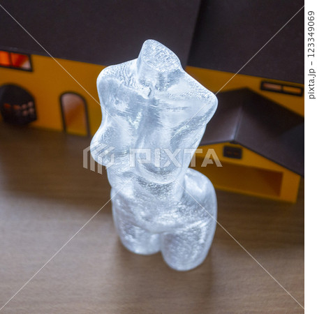 Small model of female body printed on 3D printer from molten transparent plastic. An object created on 3D printer from molten plastic. 3D printing technology. Additive modern progressive technologies 123349069