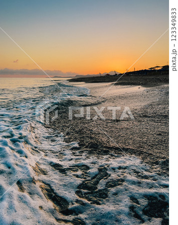 Sunset waves gently caressing golden shoreline, warm orange and pink tones softening twilight horizon with peaceful coastal serenity Sunset waves gently caressing golden shoreline, warm orange and pink tones softening twilight horizon with peaceful coastal serenity 123349833