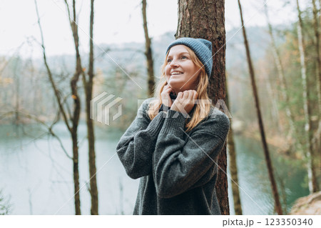 Fall autumn hiker woman outdoor at nature forest and lake for camping travel. Scenery of the majestic lake. Active lifestyle. Travel concept. High quality photo 123350340