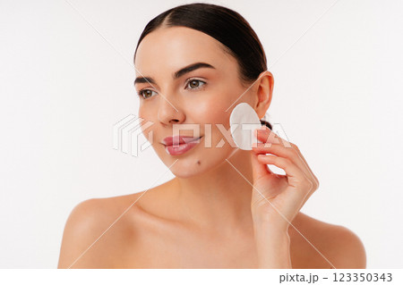 Woman Cleanses Her Face With Cotton Pad For Skincare And Beauty Routine Woman Cleanses Her Face With Cotton Pad For Skincare And Beauty Routine 123350343