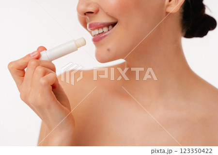 Close-Up of Person Applying Lip Balm for Soft and Healthy Lips Close-Up of Person Applying Lip Balm for Soft and Healthy Lips 123350422
