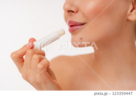 Close-Up of Person Applying Lip Balm for Hydrated Lips and Skincare Routine Close-Up of Person Applying Lip Balm for Hydrated Lips and Skincare Routine 123350447