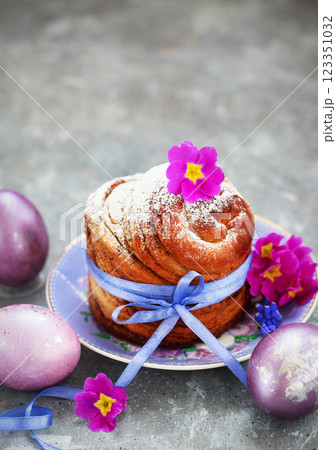 Sweet Easter bread, panettone or cruffin and colorful painted eggs, Holiday spring concept Sweet Easter bread, panettone or cruffin and colorful painted eggs, Holiday spring concept 123351032
