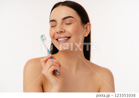 Person Smiling Holding a Toothbrush for Healthy Teeth Care Person Smiling Holding a Toothbrush for Healthy Teeth Care 123351038