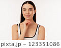 Smiling Woman Posing in Simple White Tank Top on White Background 123351086