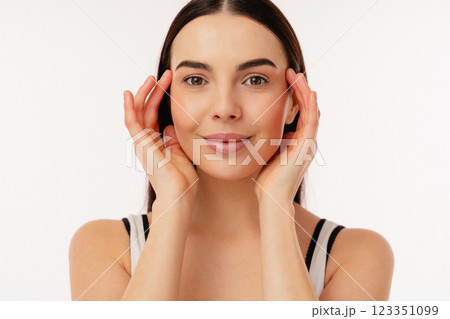Portrait of a Smiling Woman Holding Her Face With Both Hands 123351099