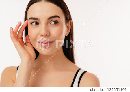 Close-Up Portrait of a Smiling Woman with a Thoughtful Expression 123351101
