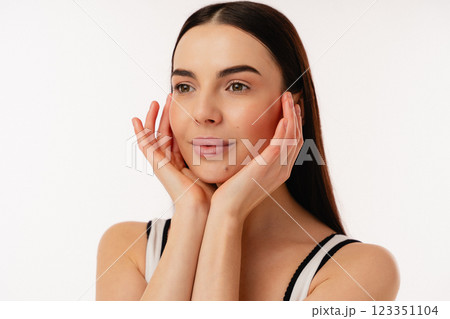 Portrait of Hands Touching Face on Isolated White Background 123351104