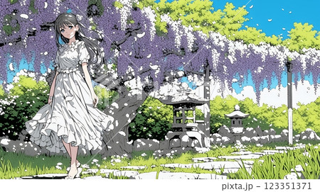 満開の藤の花の下を歩いている若い女性