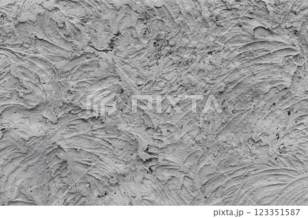 Grungy gray concrete wall with chaotic relief texture, front view 123351587