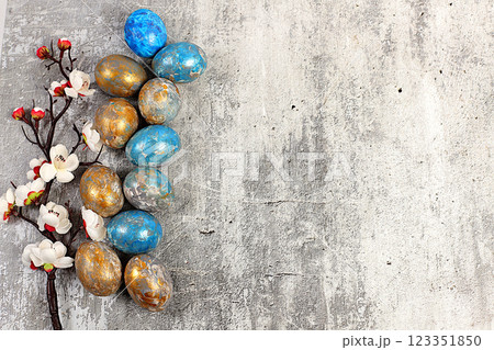 Happy Easter concept. Abstract Easter composition with marbled blue-gray decorated eggs, and flowering branches with sakura flowers, painted with hibiscus flowers. Banner for the screen with space for Happy Easter concept. Abstract Easter composition with marbled blue-gray decorated eggs, and flowering branches with sakura flowers, painted with hibiscus flowers. Banner for the screen with space for 123351850