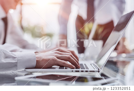 Business man sitting at table surfing the internet, online working at office, telecommuting concept Business man sitting at table surfing the internet, online working at office, telecommuting concept 123352051