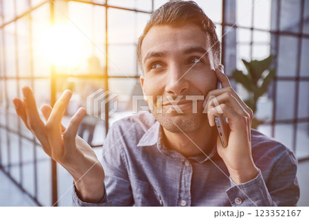 Businessman shopping over the phone in an office Businessman shopping over the phone in an office 123352167