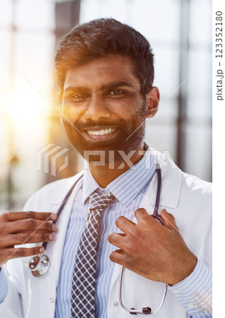 Portrait of a smiling male doctor standing in a hospital corridor Portrait of a smiling male doctor standing in a hospital corridor 123352180