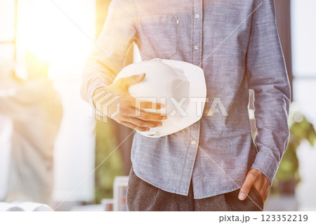 Close-up of a man holding a helmet in white 123352219