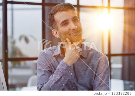 Serious thoughtful millennial business man looking away Serious thoughtful millennial business man looking away 123352293