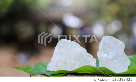 Crystal clear alum cubes or Potassium alum in on green leaves chemical compound substance concept for beauty spa and underarm treatment industrial 123352423