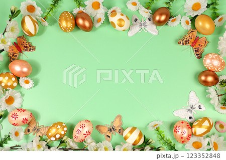 Abstract spring easter composition with golden painted eggs, feathers, butterflies, blossom branches and flowers. Happy easter concept. Screen banner with space for greeting text, Abstract spring easter composition with golden painted eggs, feathers, butterflies, blossom branches and flowers. Happy easter concept. Screen banner with space for greeting text, 123352848
