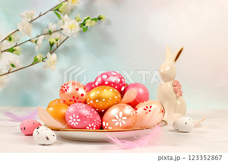 Happy Easter concept. Abstract Easter composition with pink and gold decorated eggs, feathers, flowering branches and flowers. Banner for screen with space for greeting text Happy Easter concept. Abstract Easter composition with pink and gold decorated eggs, feathers, flowering branches and flowers. Banner for screen with space for greeting text 123352867