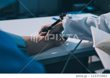 Doctor using sphygmomanometer with stethoscope checking blood pressure to a patient in the hospital. Doctor using sphygmomanometer with stethoscope checking blood pressure to a patient in the hospital. 123353062