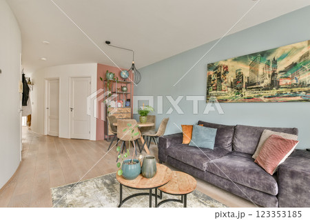 A stylish modern living room featuring a cozy sofa, vibrant artwork, and elegant furniture, creating a welcoming ambiance for relaxation and entertainment. A stylish modern living room featuring a cozy sofa, vibrant artwork, and elegant furniture, creating a welcoming ambiance for relaxation and entertainment. 123353185