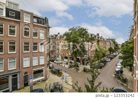 A picturesque view of a quiet street featuring classic architecture, lined with trees and parked bicycles. This scene embodies urban life and charm. A picturesque view of a quiet street featuring classic architecture, lined with trees and parked bicycles. This scene embodies urban life and charm. 123353242