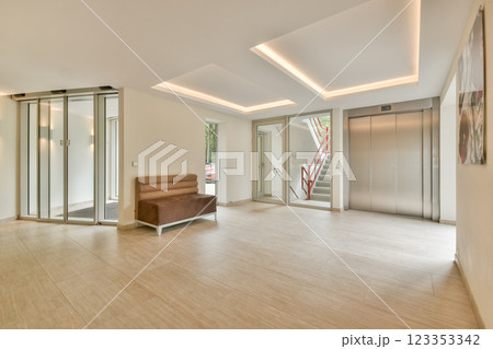 A sleek and modern interior lobby featuring stylish lighting, an elevator, and a minimalistic design. Perfect for contemporary architectural showcases. A sleek and modern interior lobby featuring stylish lighting, an elevator, and a minimalistic design. Perfect for contemporary architectural showcases. 123353342