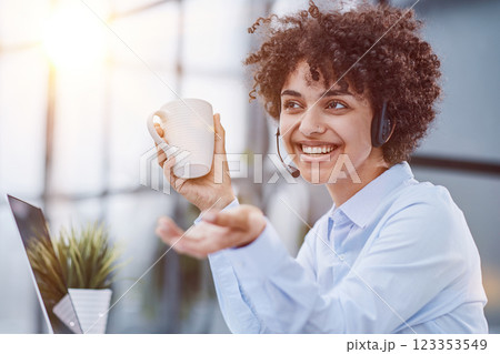 girl in a modern office working in a call center smiling 123353549