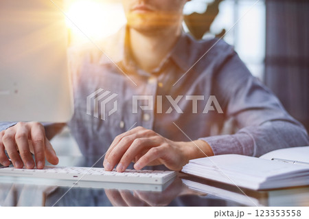 Hands of freelancer typing on laptop at home 123353558