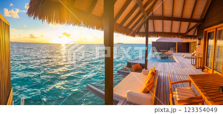 Sunset views from overwater pool villa in Maldives 123354049