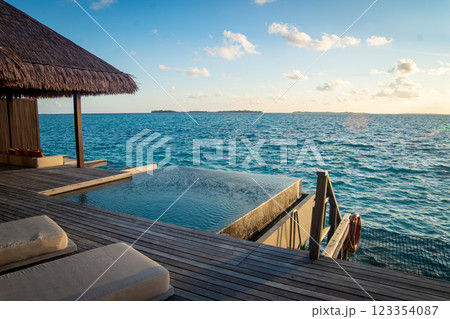Sunset views from overwater pool villa in Maldives Sunset views from overwater pool villa in Maldives 123354087