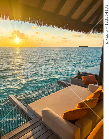 Sunset views from overwater pool villa in Maldives Sunset views from overwater pool villa in Maldives 123354131