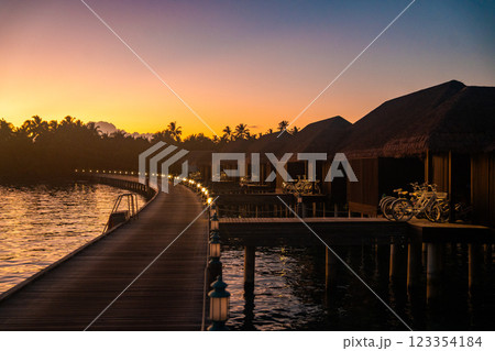 Sunset views from overwater pool villa in Maldives 123354184