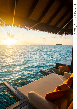 Sunset views from overwater pool villa in Maldives 123354221